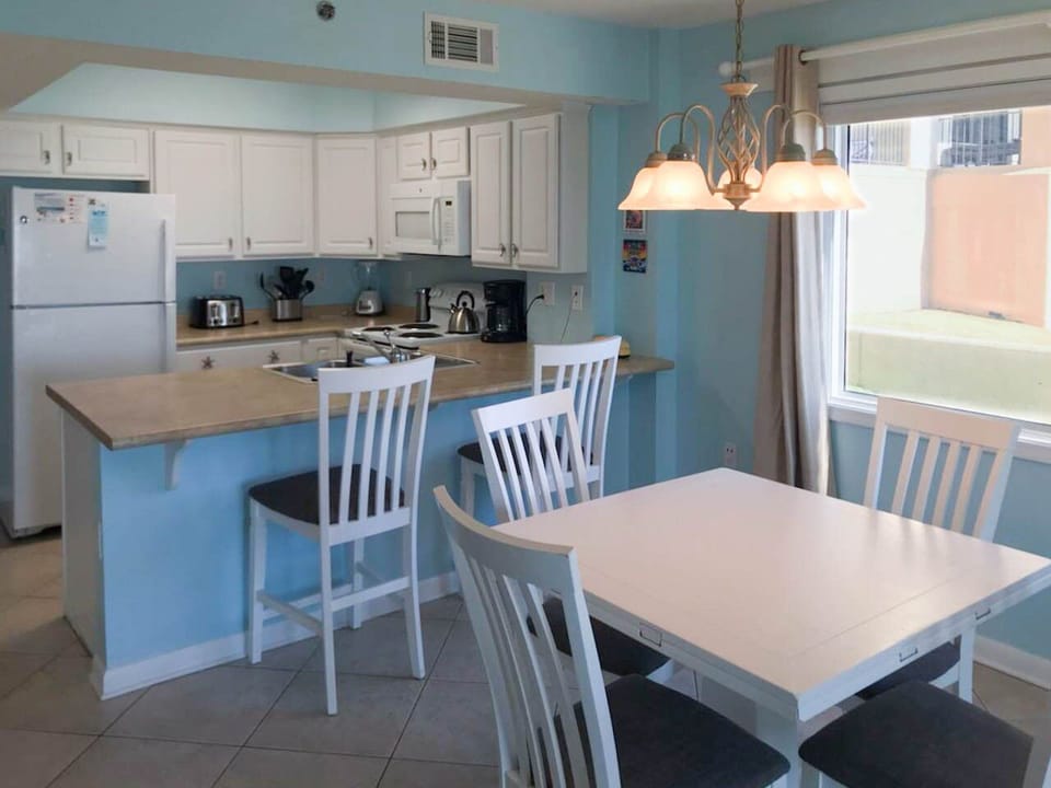 Dining table and breakfast bar provide ample seating at meal time