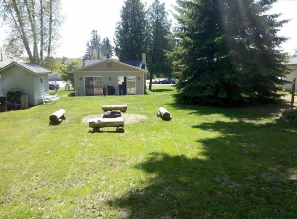 View from Bike Path in Back of Yard Toward Fire Pit Circle to Shed to Cottage.