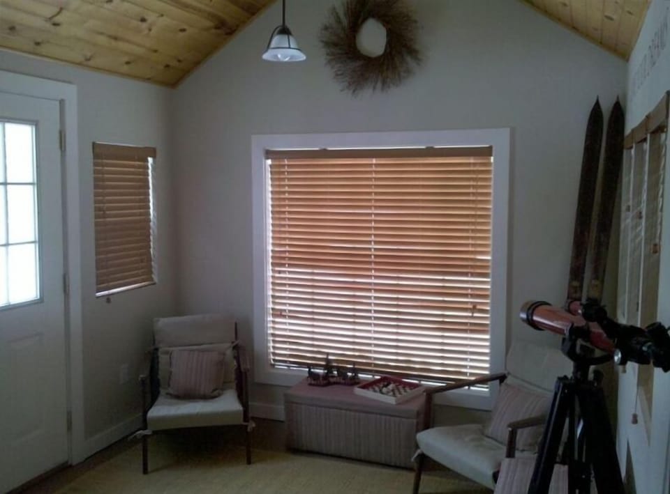 View from Living Room Into Connected Sun Porch & Front Door on Left