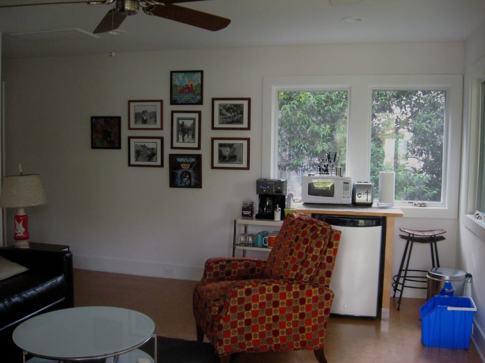 Living room and frig, microwave, toaster and coffee area.