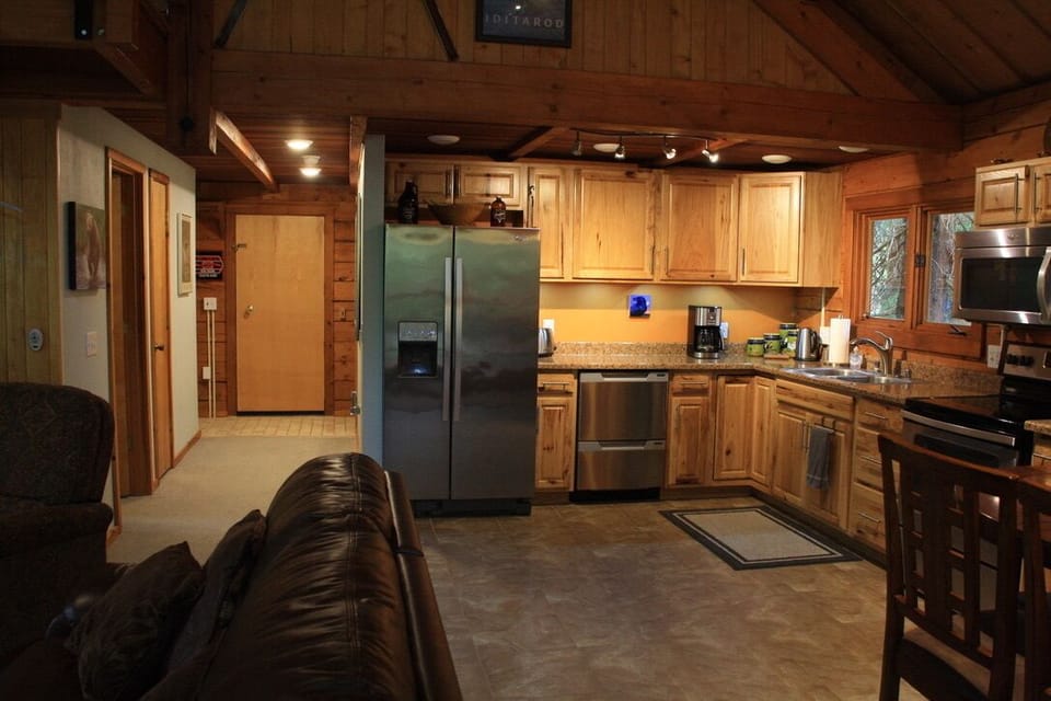 Kitchen and hallway leading to bedroom and full bathroom.