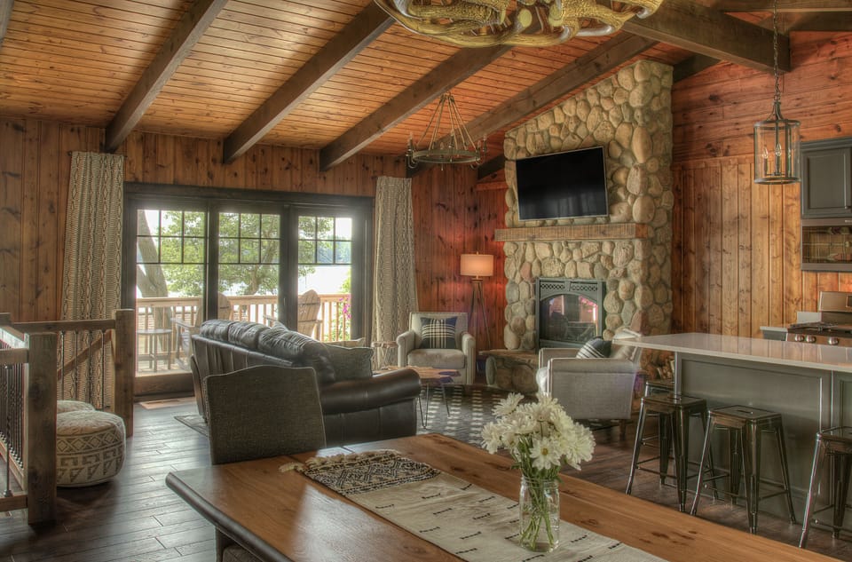 Open concept main level with walk out to deck and incredible panoramic lake view