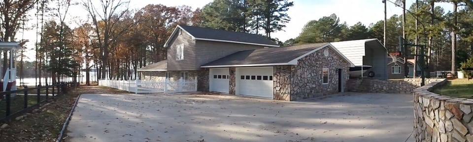 Concrete drive, 2-car garage and basketball area. Private path to water.
