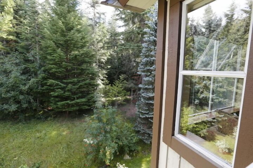 Enjoy the peace and serenity of a mountain retreat home from the covered balcony