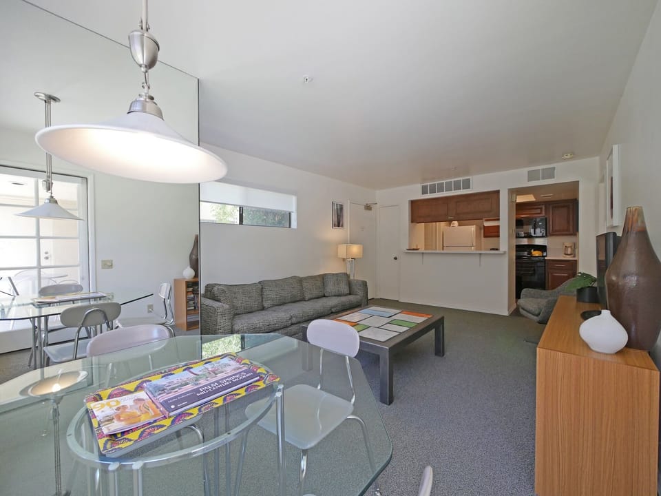 The sun drenched living room has new roller blinds &  8ft comfortable couch