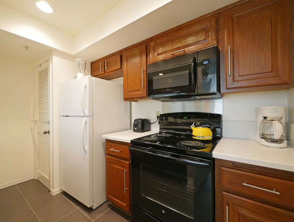 Fully equipped kitchen has new stove & built in microwave.  tea kettle, toaster
