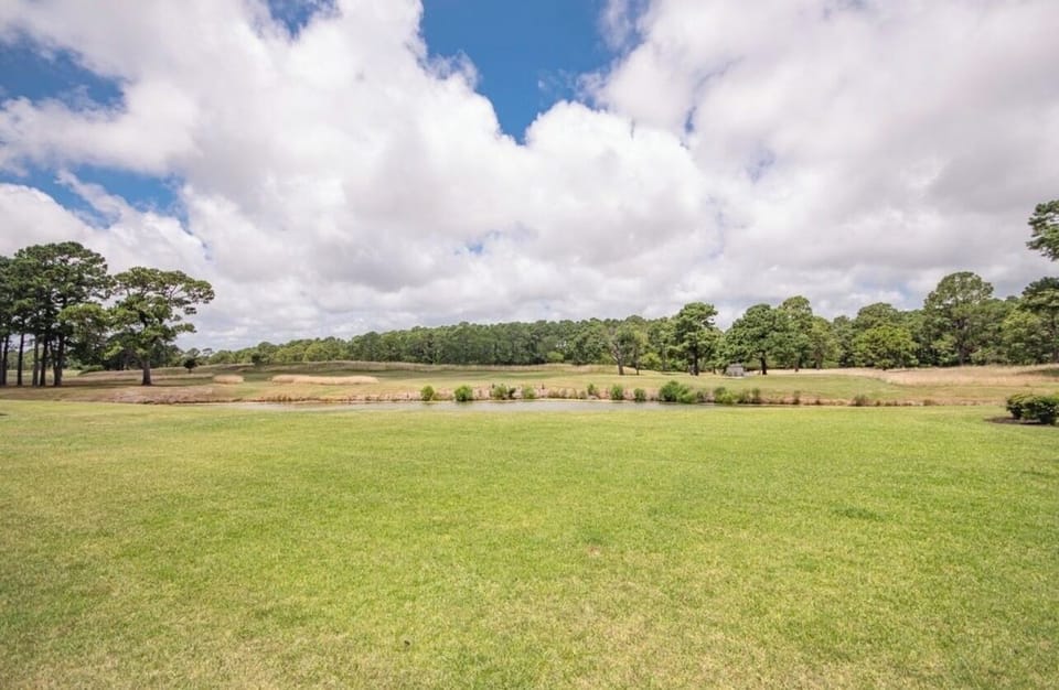 Yard area overlooking stream and golf course