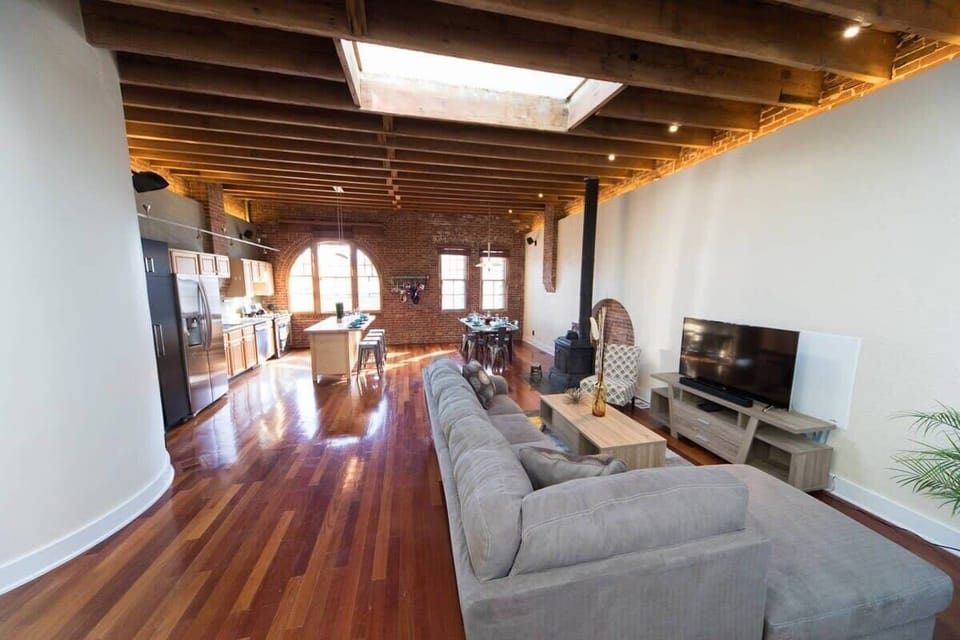 Too lazy to go to your bedroom? This living room features a designer leather couch that turns into a queen sized bed.
