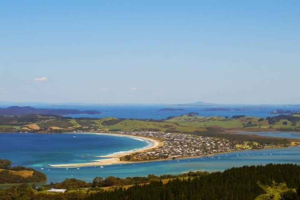 Omaha Beach and estuary from Whangateau. Kawau and Rangitoto in the distance