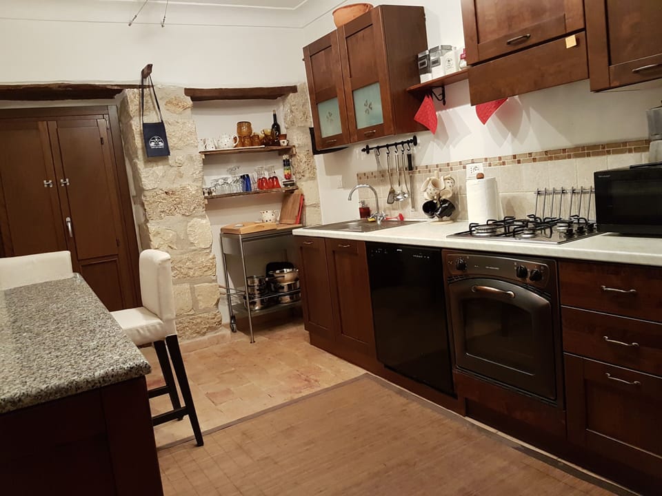 Opposite kitchen view with doors overlooking small courtyard.