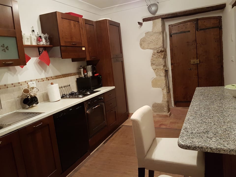 Our fully equipped kitchen with doors leading to terrace.