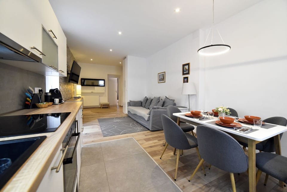 Dining area with kitchen and the view to the living area and entrance to the bed
