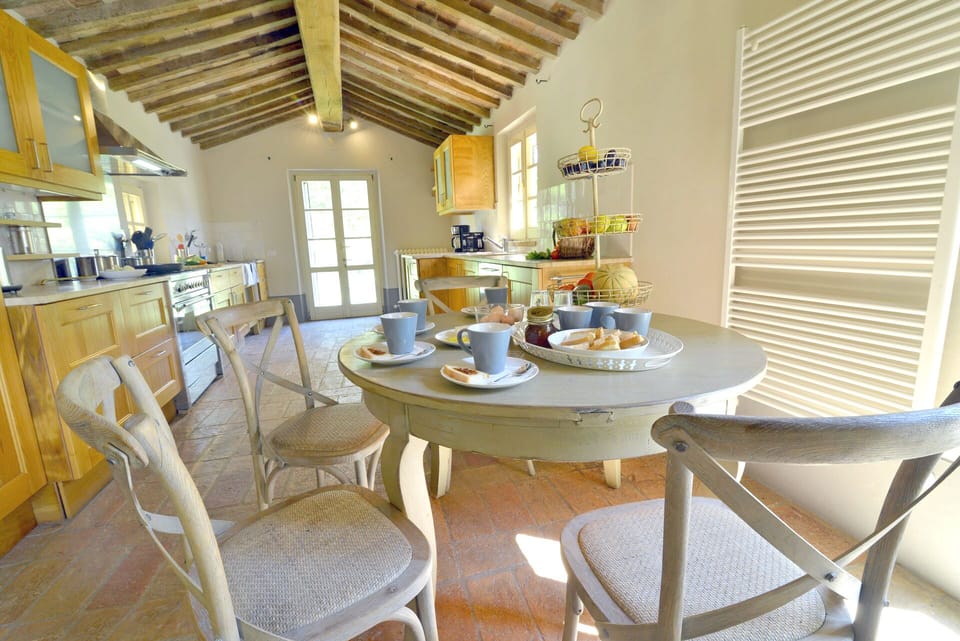 Fully equipped kitchen with access to the garden and outside dining.