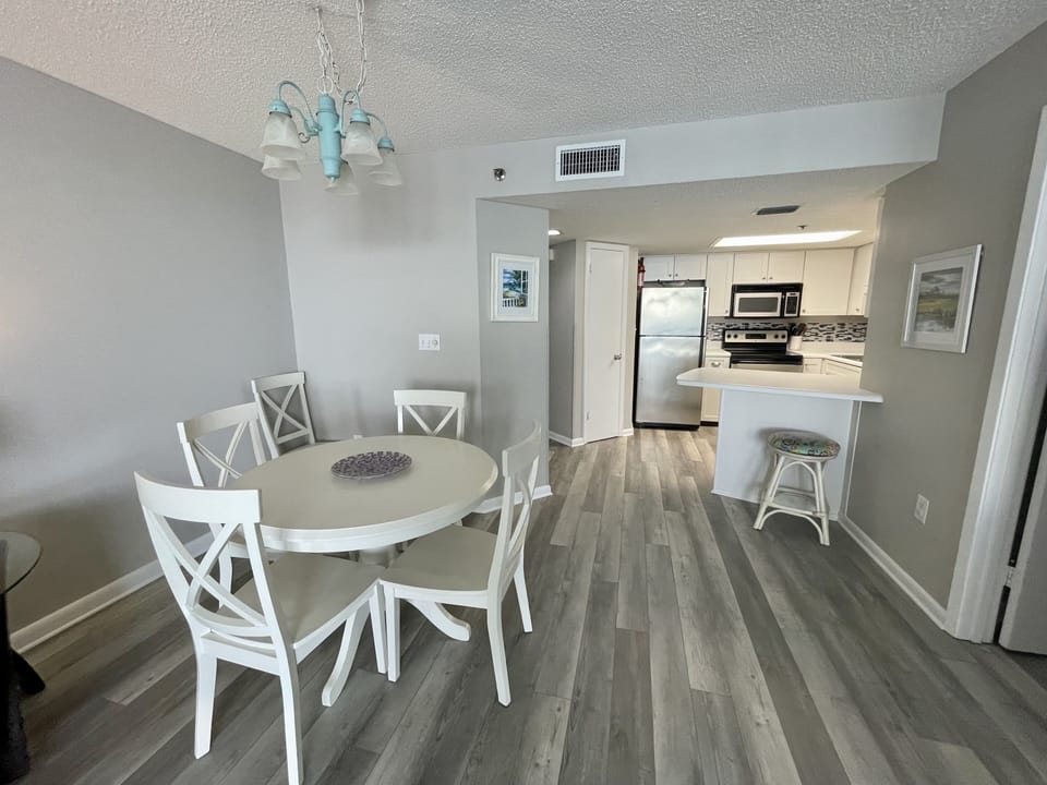 Kitchen, Hardwood Floor, Chairs, Table, Stool, White Cabinets, Art, Stainless.