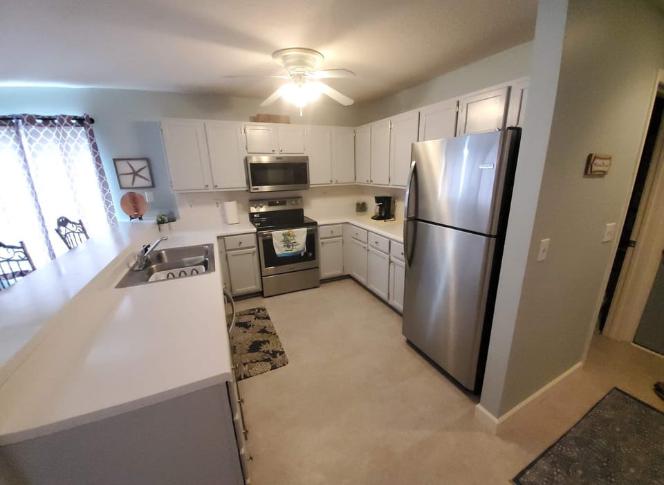 Kitchen with stainless steel appliances. 