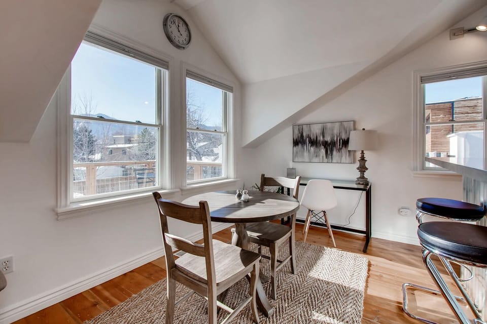 Sun-filled dining area, counter bar, and dedicated, laptop-friendly desk. 