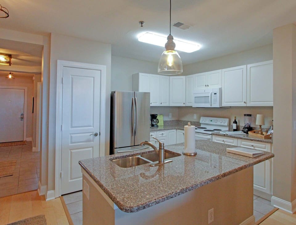 Large kitchen with granite countertops.