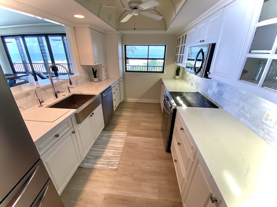New marble kitchen with stainless appliances, wood floors, and full beach views!