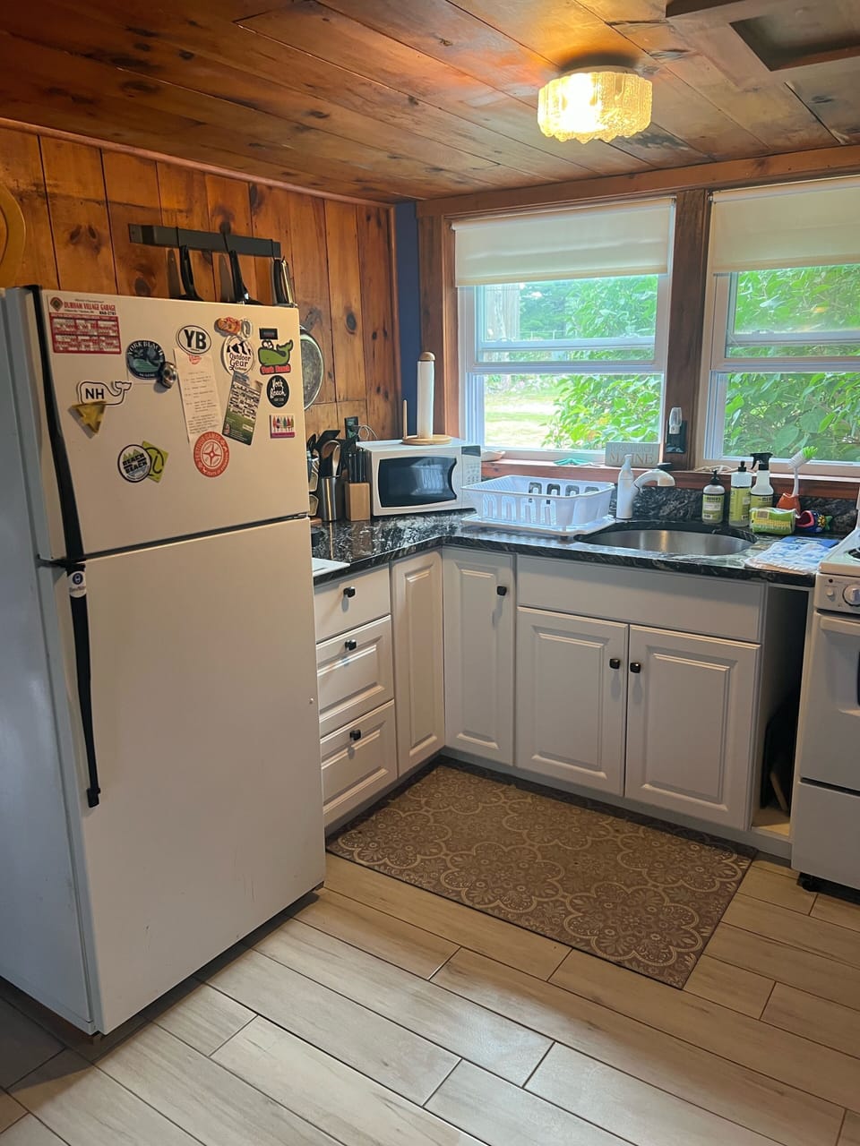 Kitchen with granite counter tops, microwave, Keurig, small stove 