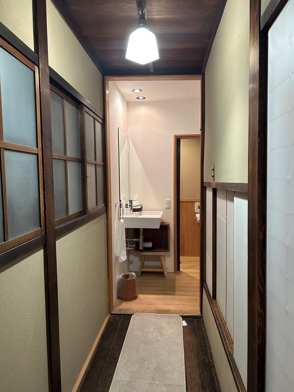The bathroom is in the back.