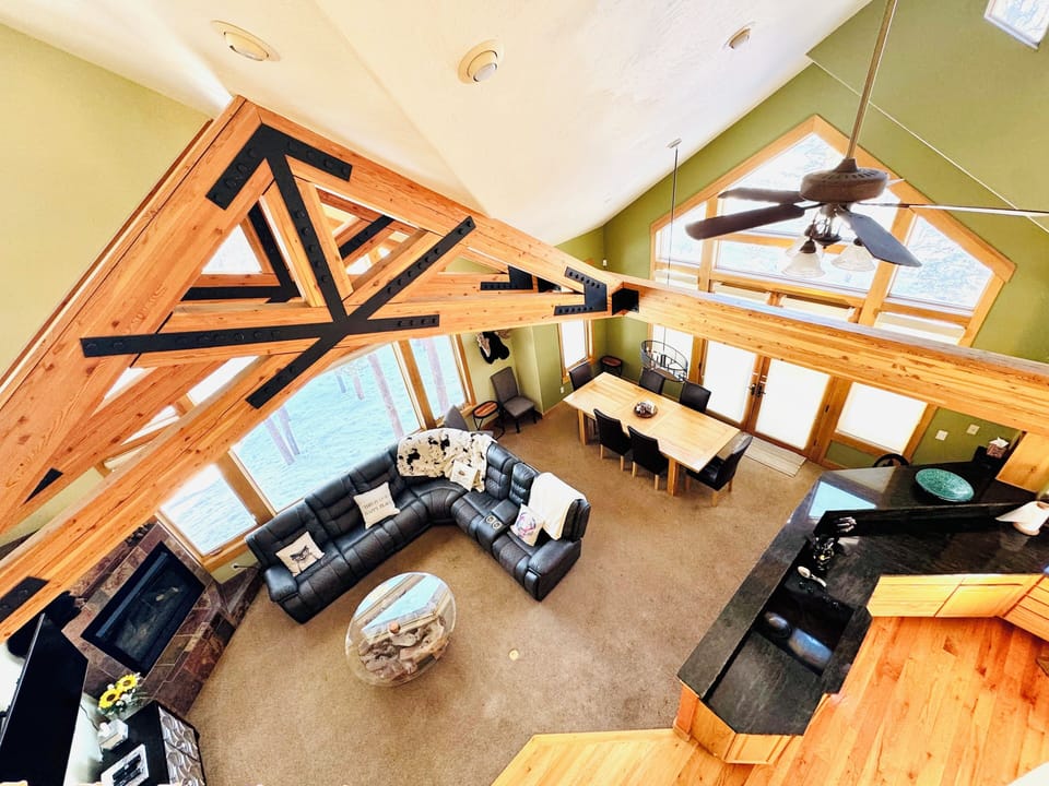 Open floorplan living room with access to kitchen, dining room, bathroom, patio