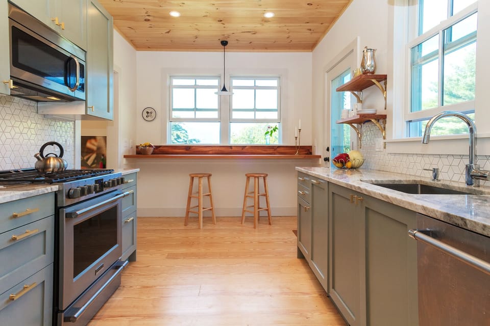 Gourmet kitchen with mountain views north and forest views east.