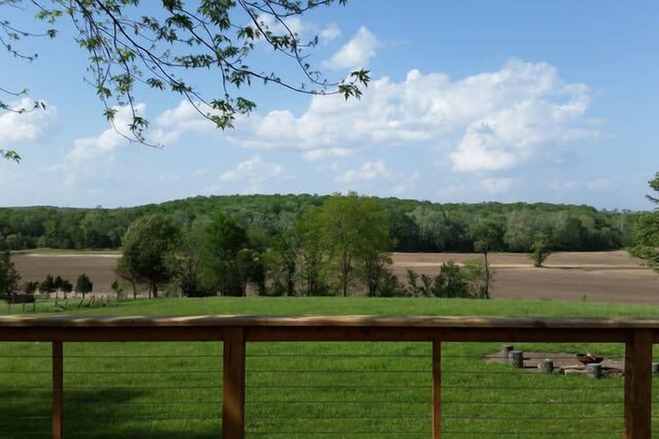 Relax on the deck with views that overlook farmland and forest.