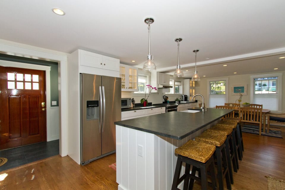 Custom kitchen with leathered granite counters and stainless steel appliances.