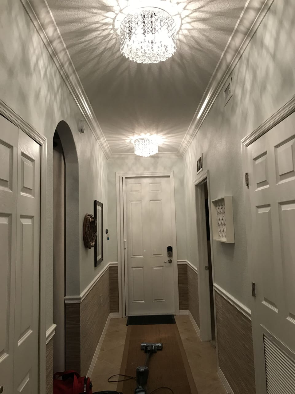 Seagrass wainscoting and updated chandeliers