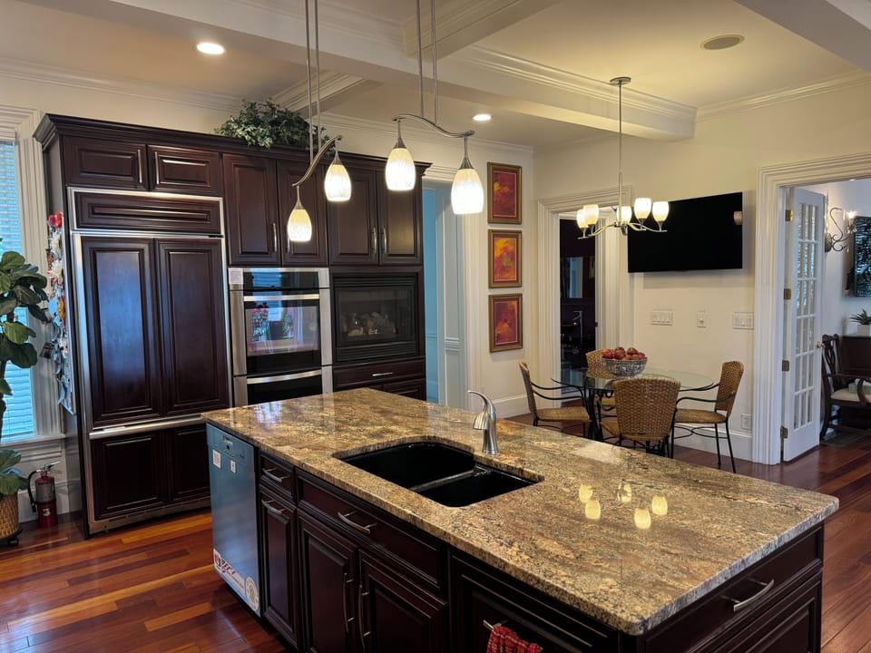 Spacious Kitchen with Fireplace, Double Oven and GE Monogram Refrigerator