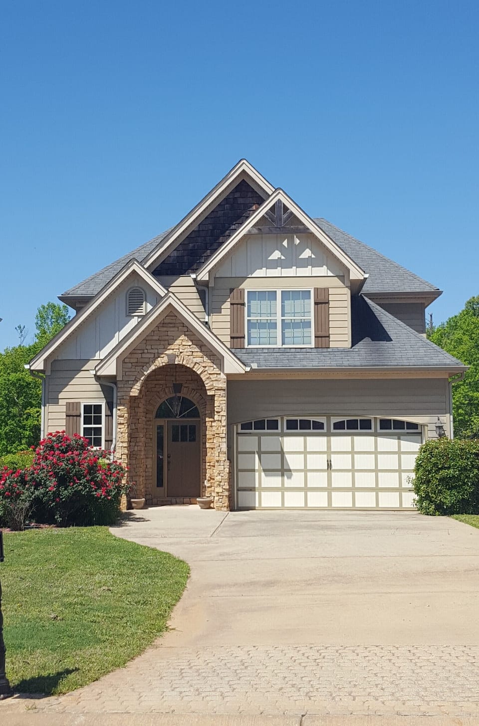 Front of house with 2 car garage and room for 4 cars in the driveway.