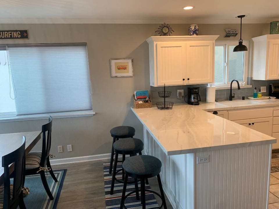 Kitchen counter with bar stools. 
