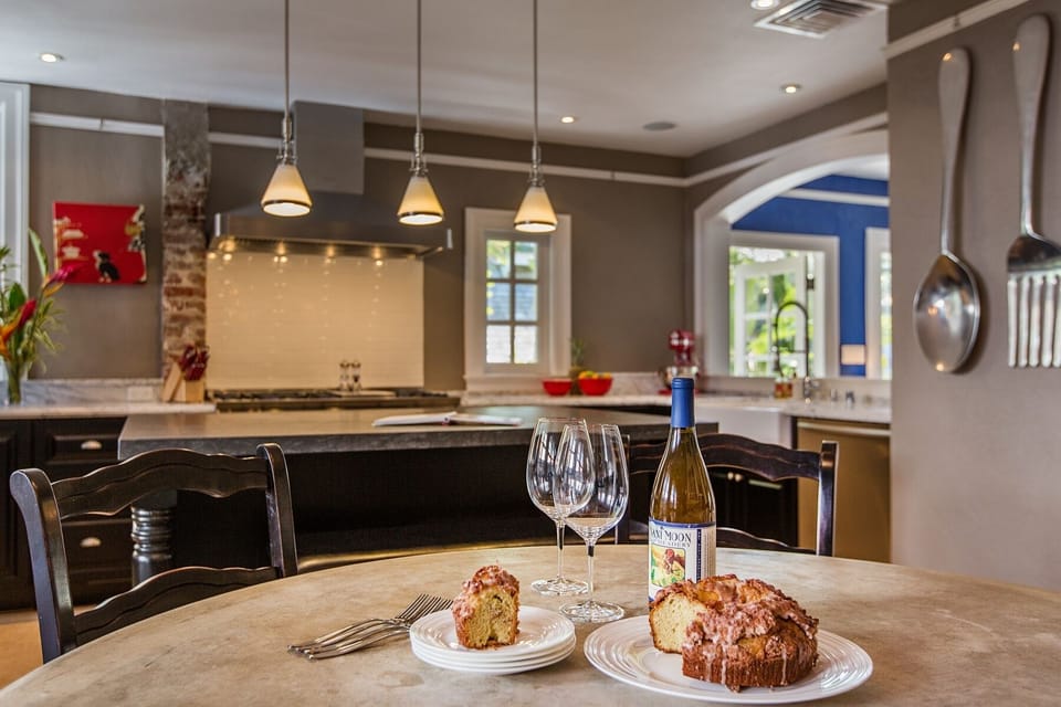 The home features an expansive kitchen with marble counters, custom cabinetry, and top-of-the-line appliances—perfect for preparing island-inspired meals.