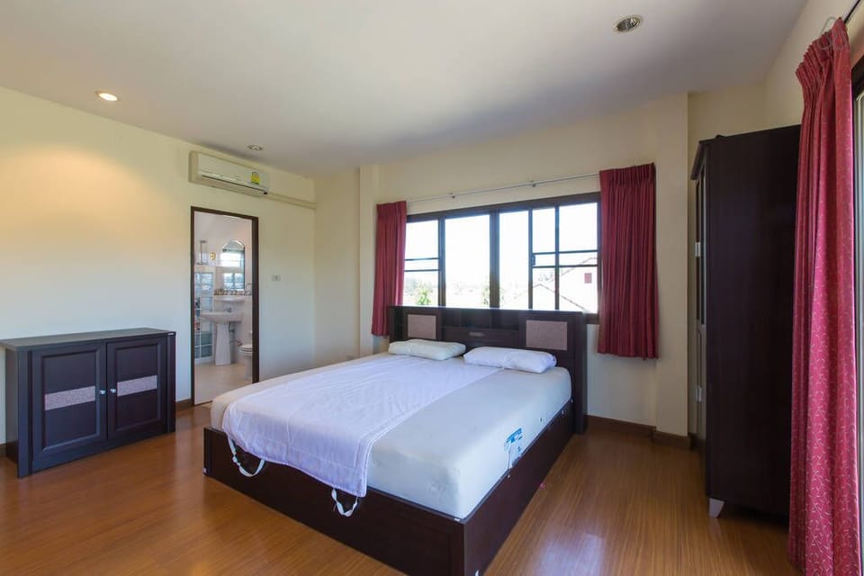Master bedroom with kingsize bed and bathroom