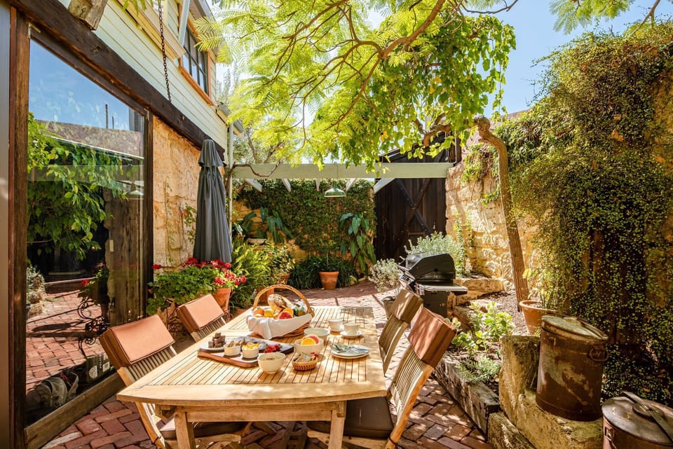 Beautiful outdoor dining and alfresco area under the shady poinciana..