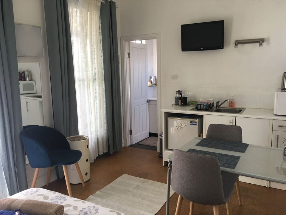 Lovely bright sitting area with tv and kitchenette/dining table