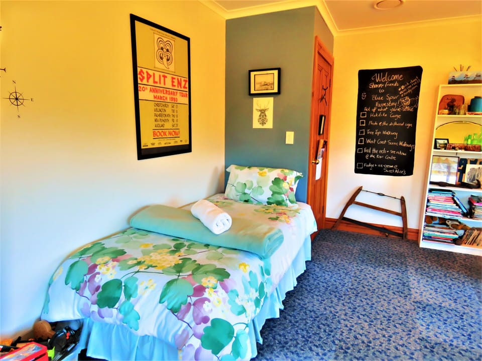 3 single beds in a spacious bedroom.