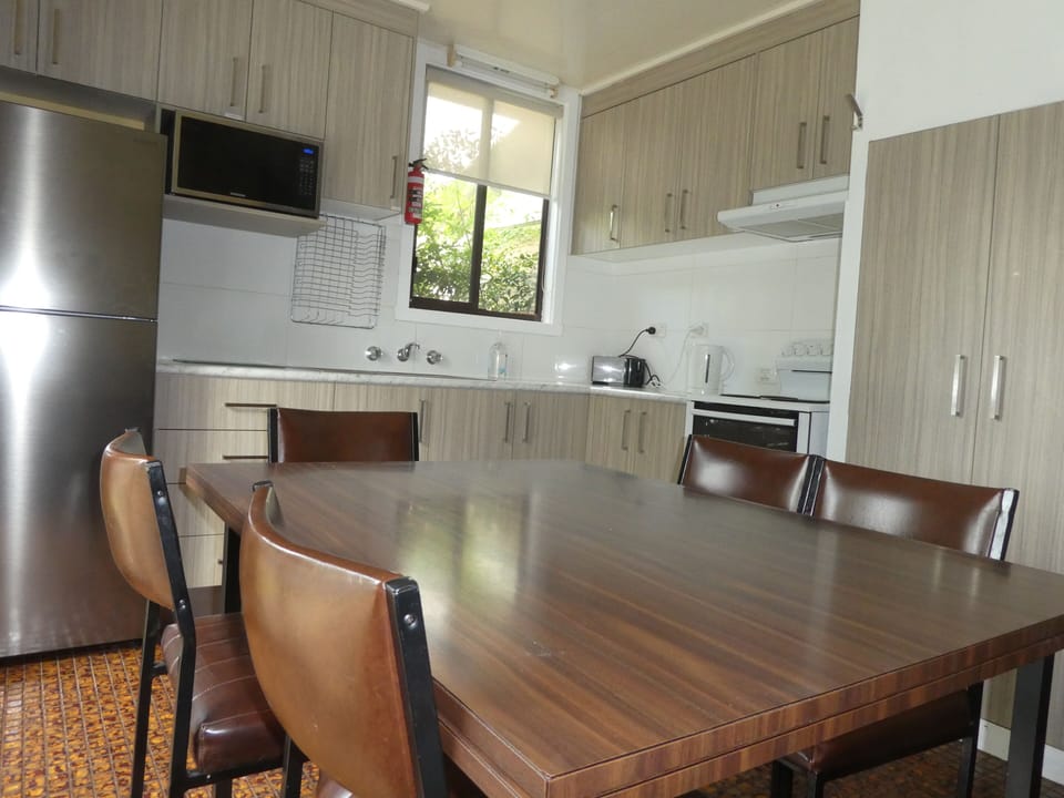 Full kitchen with full size refrigerator, stove, microwave, and utilities