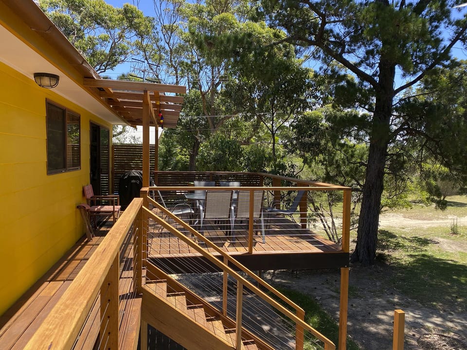 Steps from the deck lead down to the backyard