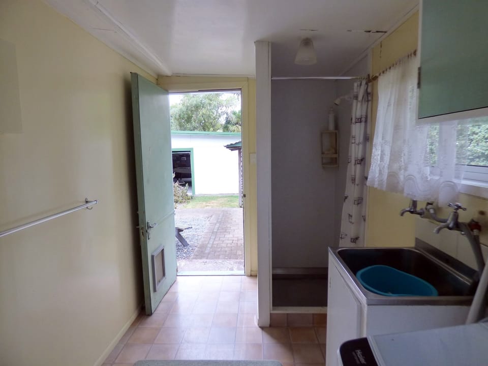 back door looking to woodshed and pool table carport