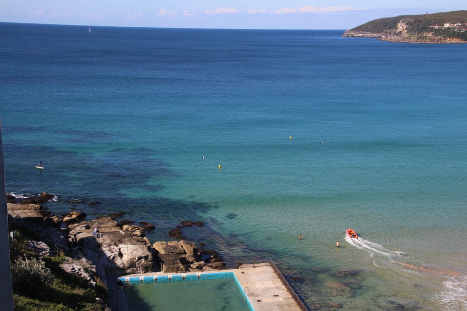 Spot our son and friend Stand Up Paddle boarding (balcony shot) 
