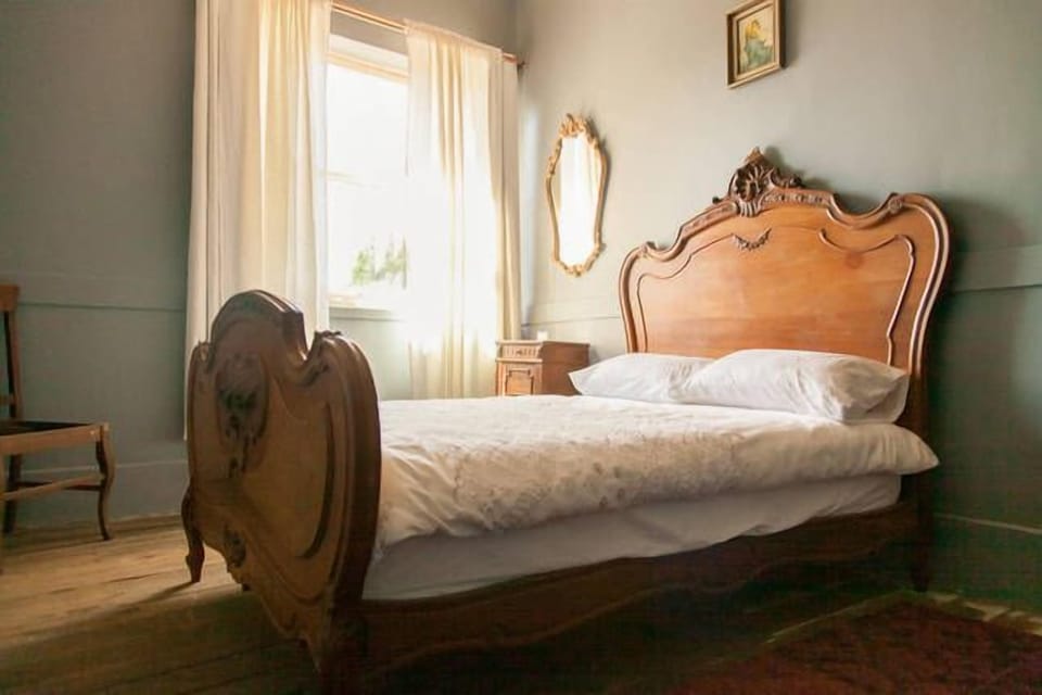 A typical bedroom at The Pill Factory. Antique beds in every room.