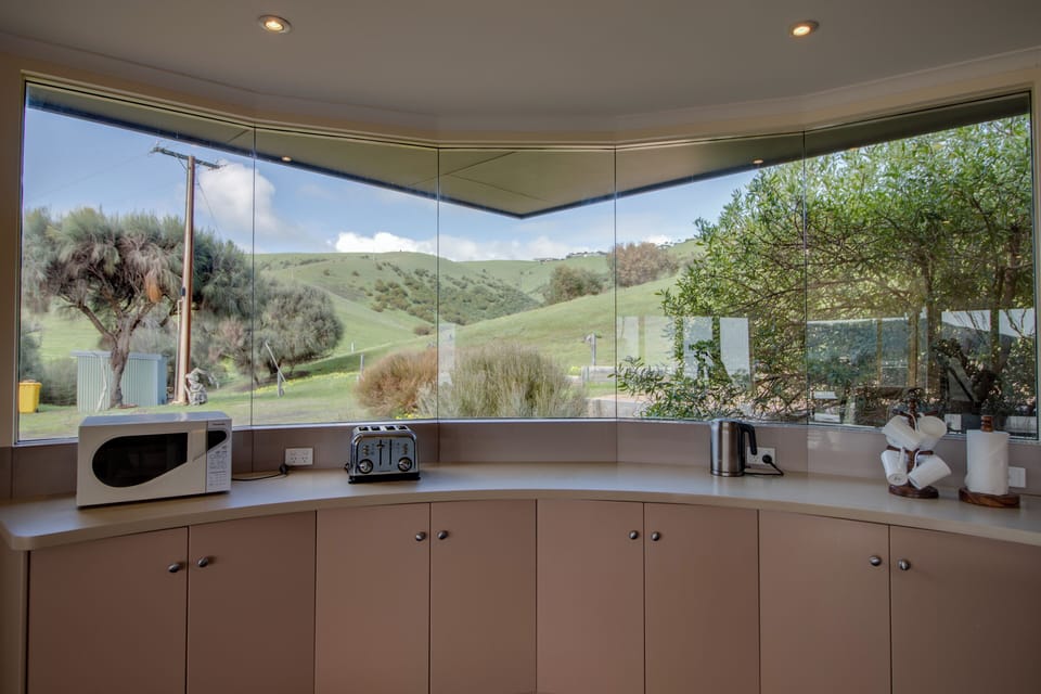 Kitchen with miele appliances - cooktop, oven and dishwasher.