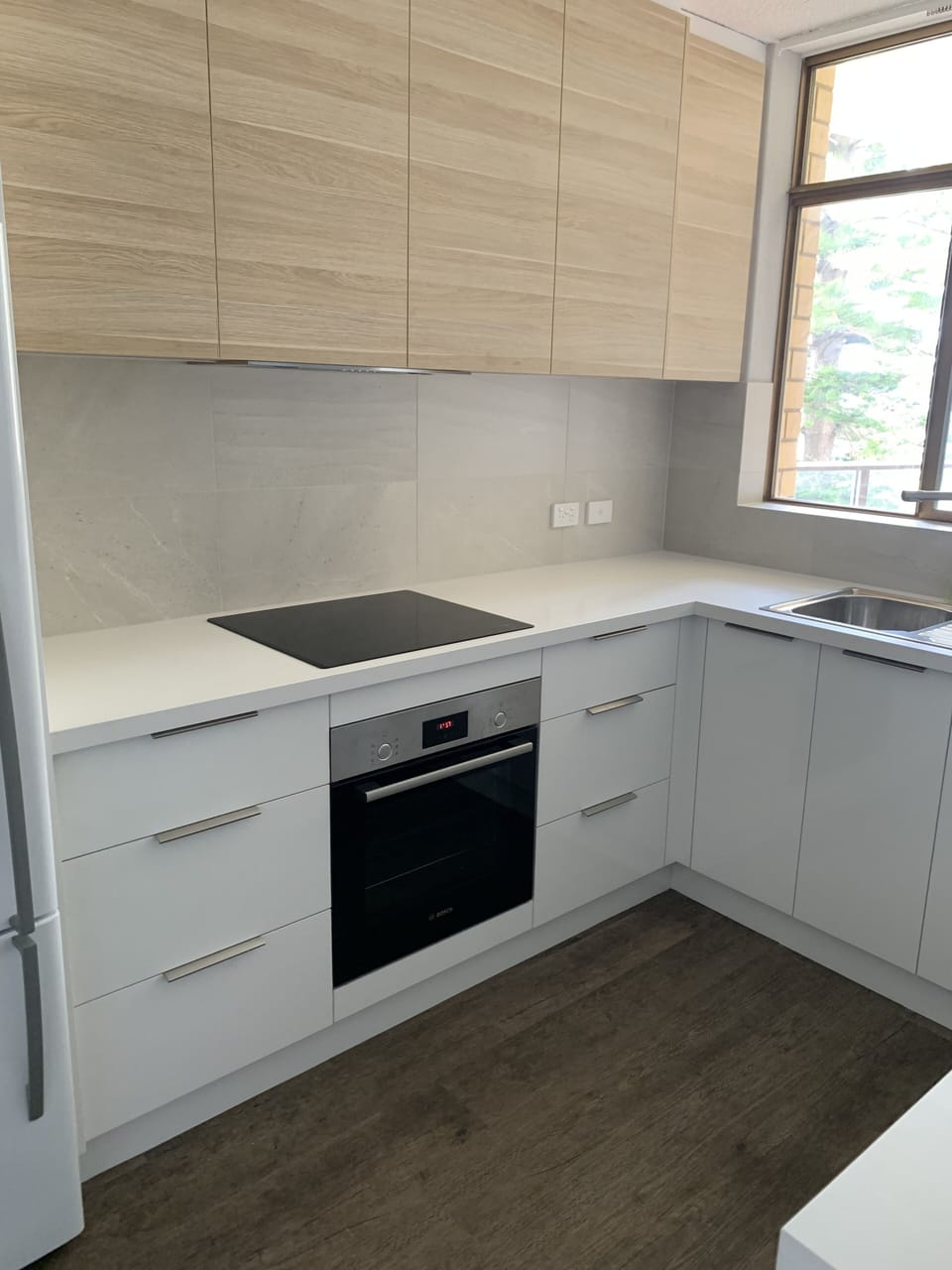Newly renovated kitchen with crockery, utensils and cookware