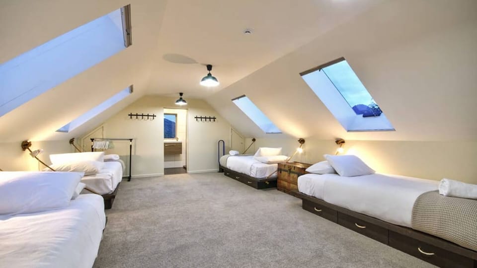 The loft in the evening looking towards the ensuite.
2 singles & 2 king singles