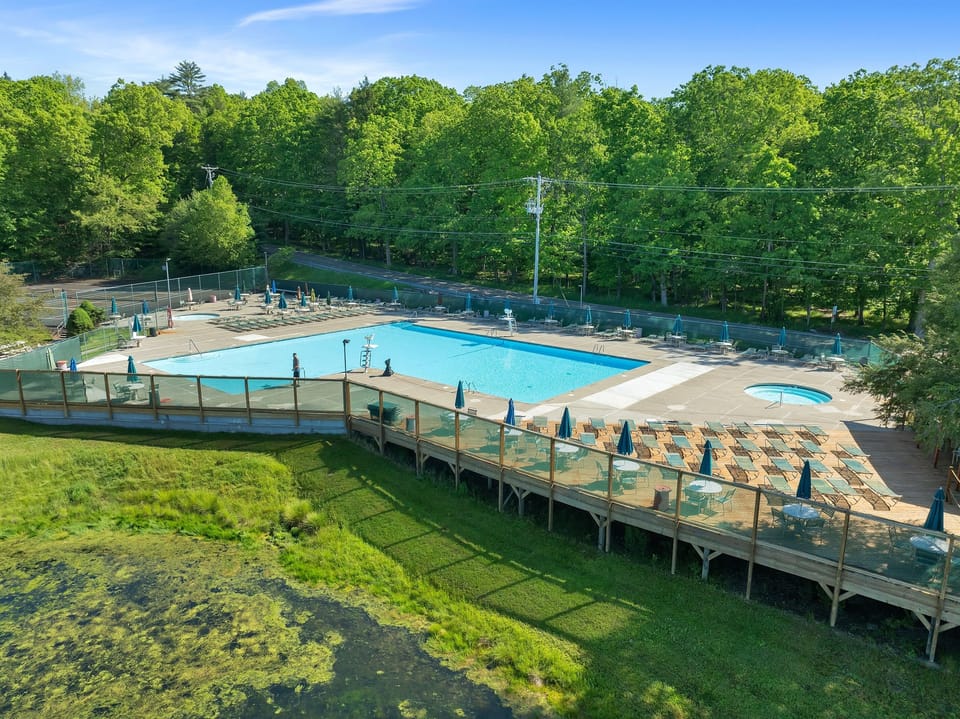 Poolside paradise! relax by the pool, hot tub, and scenic pond for a fun day.