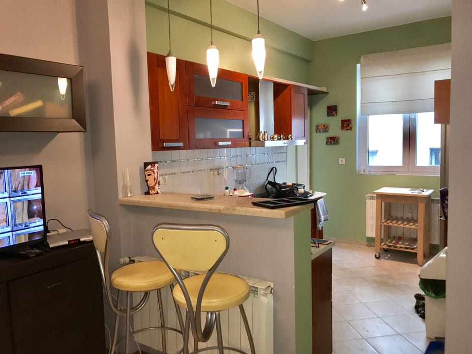 TV in Living Room and Entrance to Kitchen.