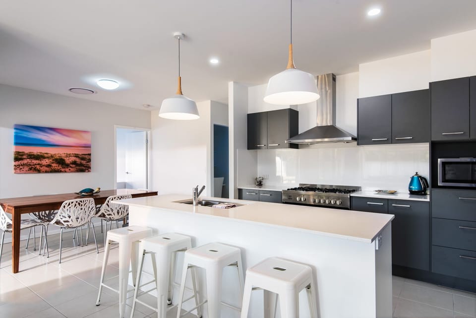 Full modern kitchen with large island bench and dishwasher 