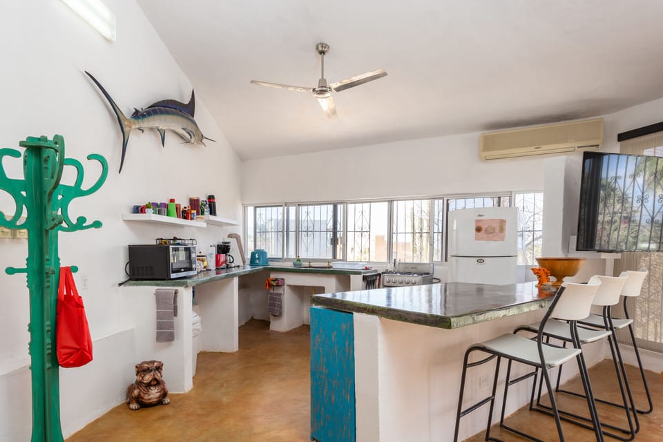 The kitchen and living room is equipped with AC and ceiling fans.