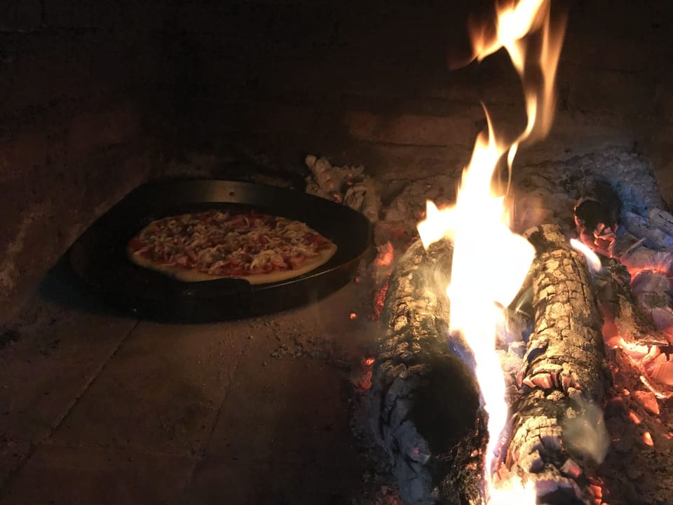 Cooking a pizza in the clay oven